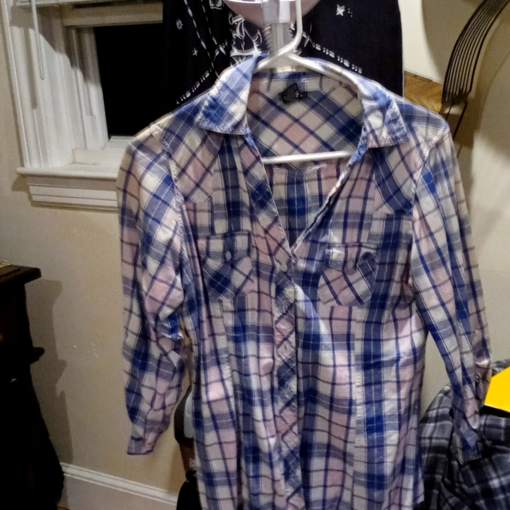 A light blue white and pink button up shirt with a v-neck